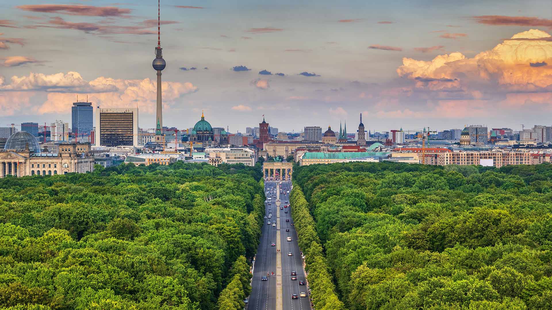 The Green Tiergarten park with the Brandenburg Gate in the distance