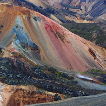 hiker and colourful mountains in landmannalaugar iceland