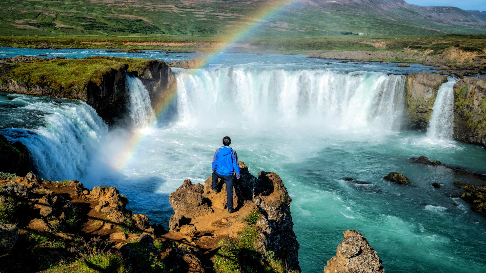 Tourist Overlooking Goðafoss Waterfall, Iceland