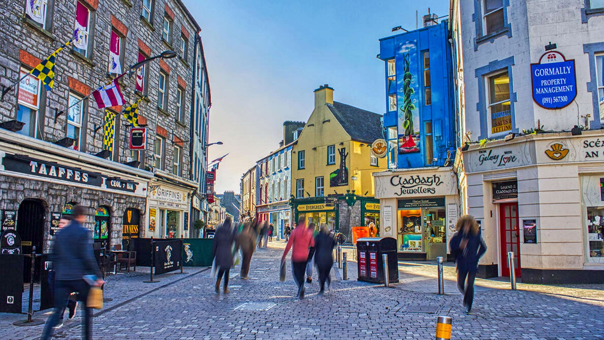 Bustling Shop Street with colourful buildings in Galway