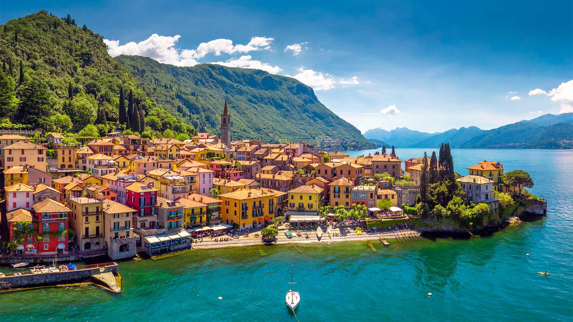 Aerial view of Varena on Lake Como with mountains, Italy