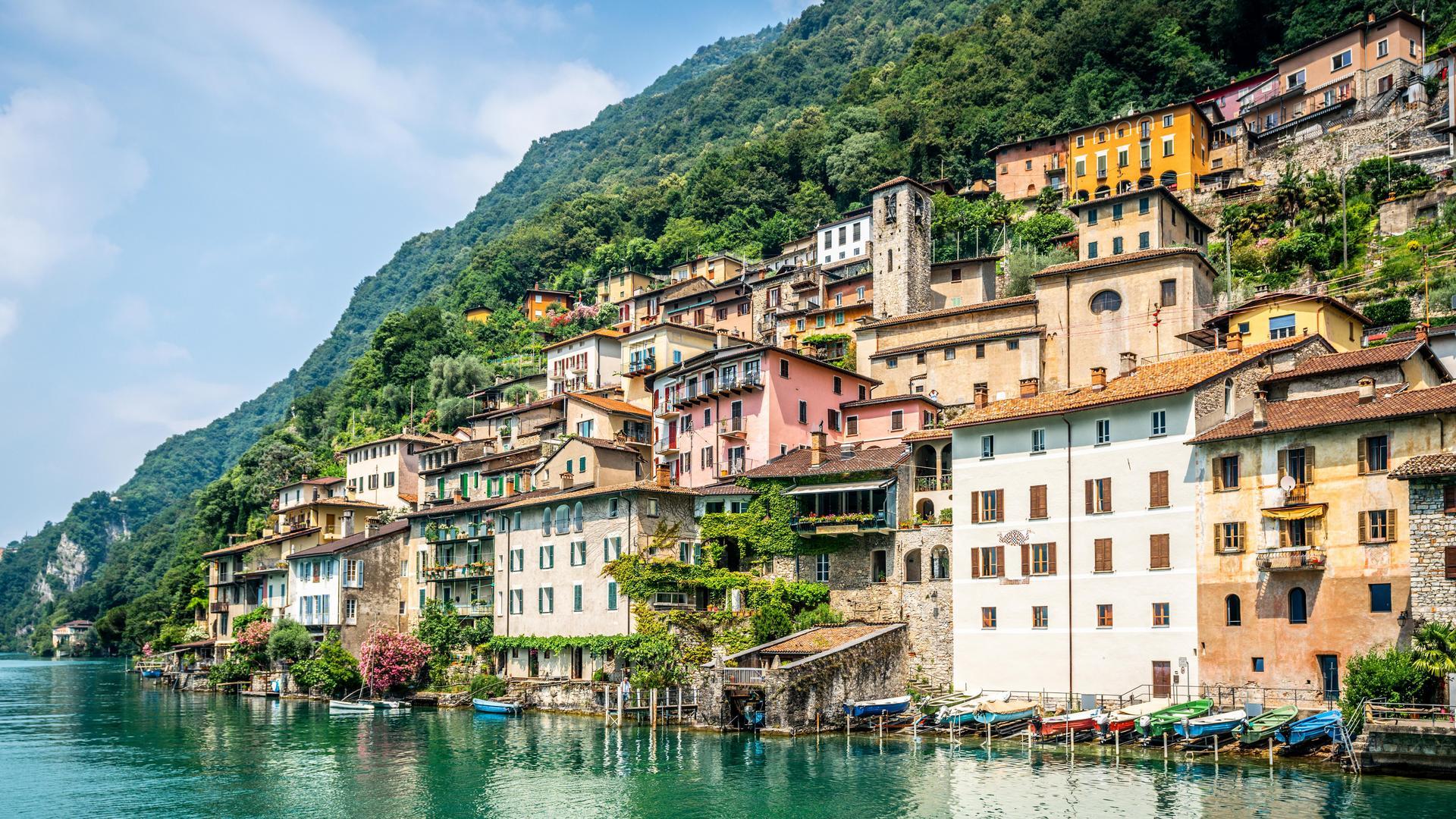 View of Gandria fishermen village with colorful houses on Lake Lugano lakeside on beautiful summer day in Switzerland 