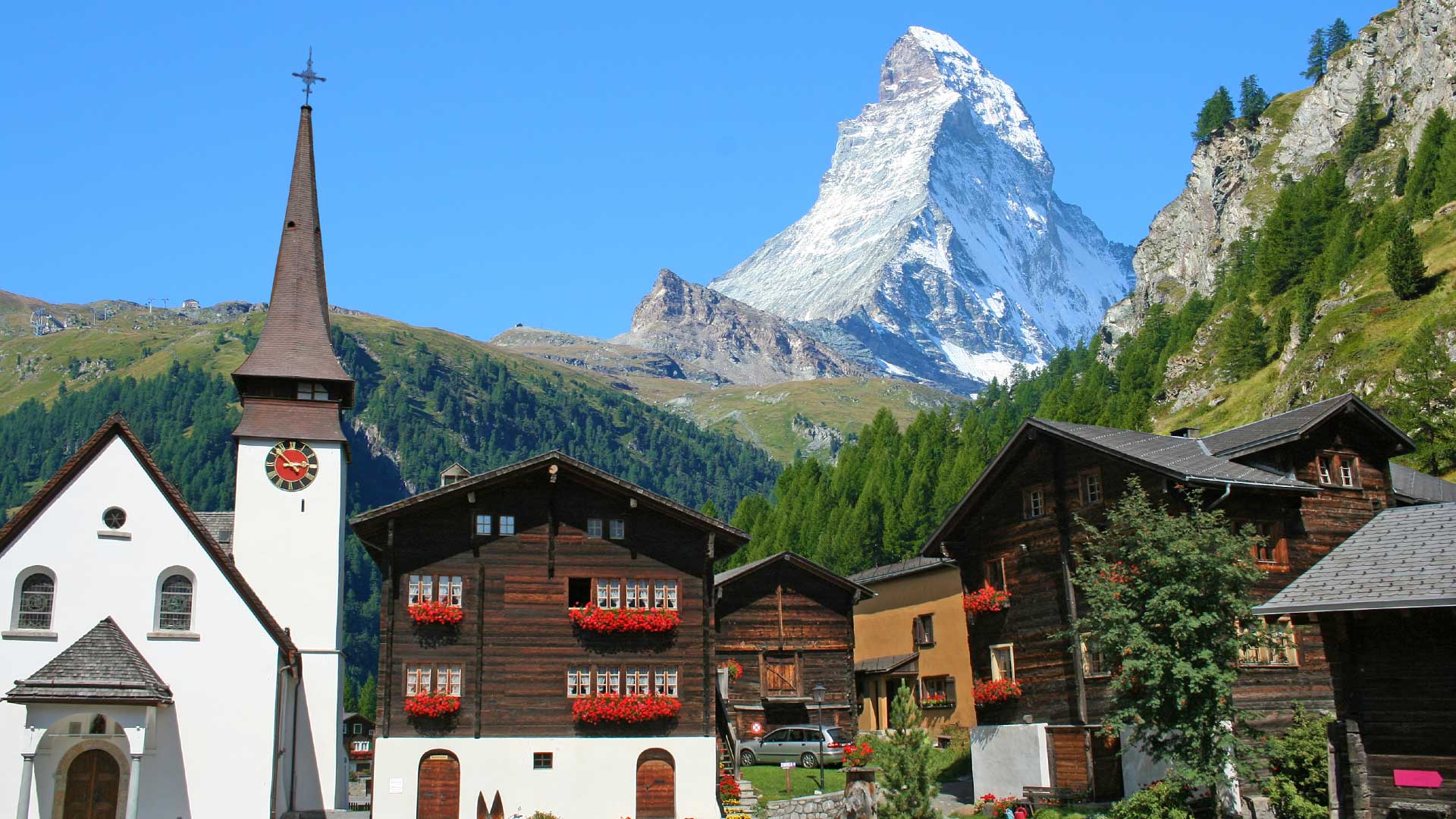 Houses and a church in Zermatt with a view of the Matterhorn