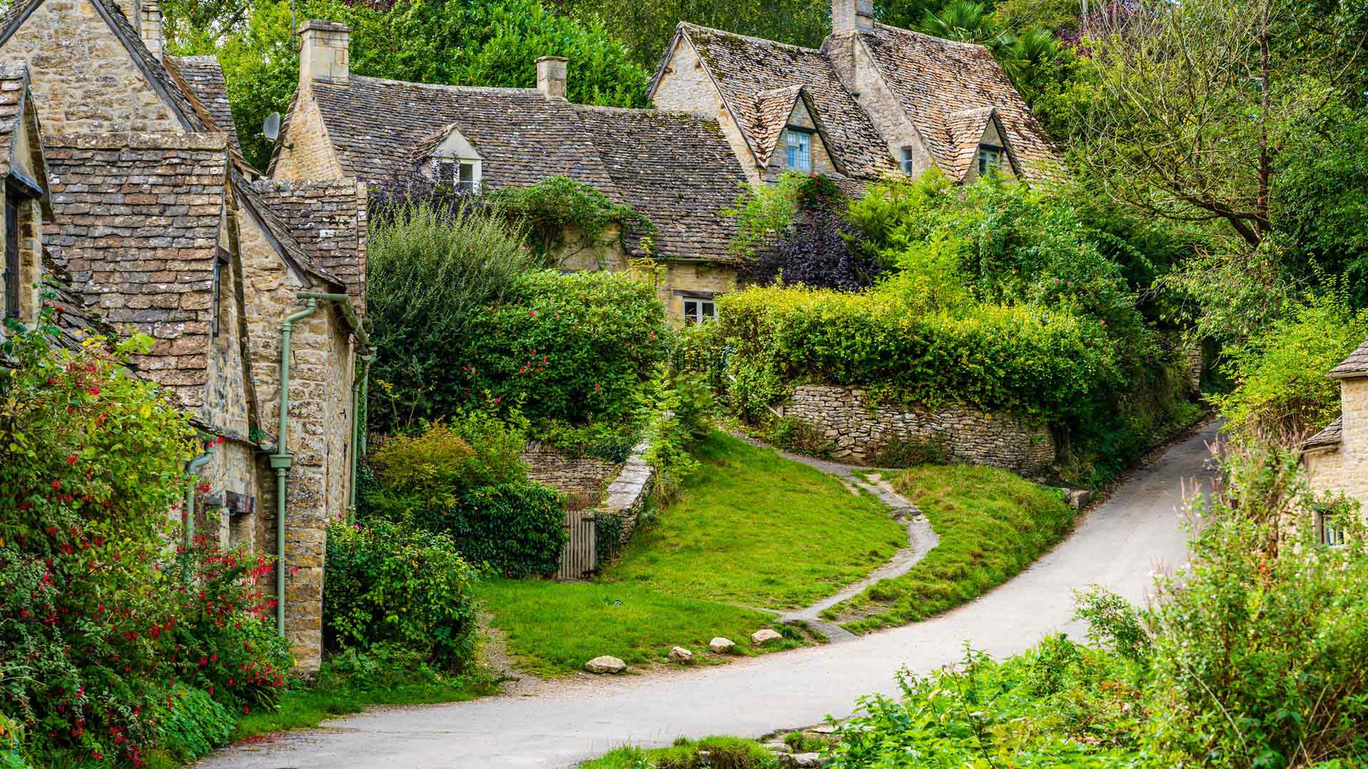 Traditional row of stone cottage houses on Arlington Row in Bibury village, Gloucestershire