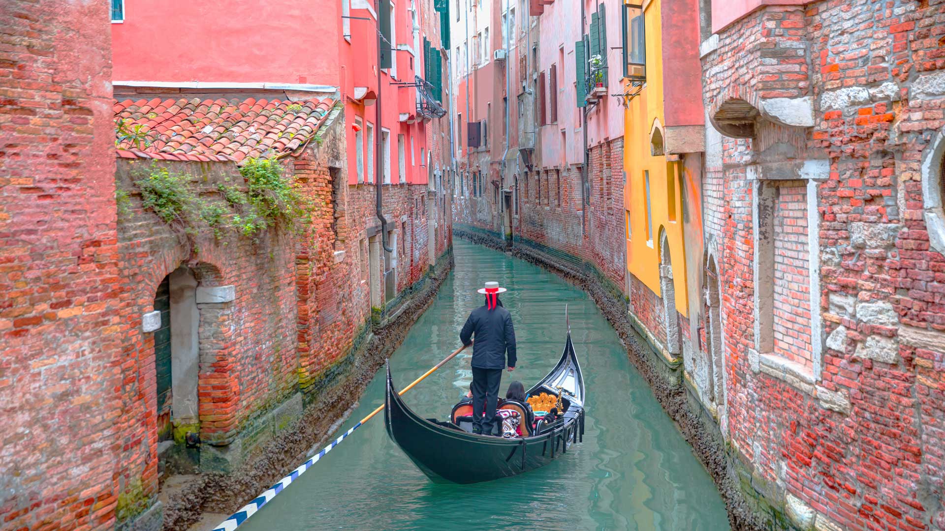 Gondolier punting gondola in Venice