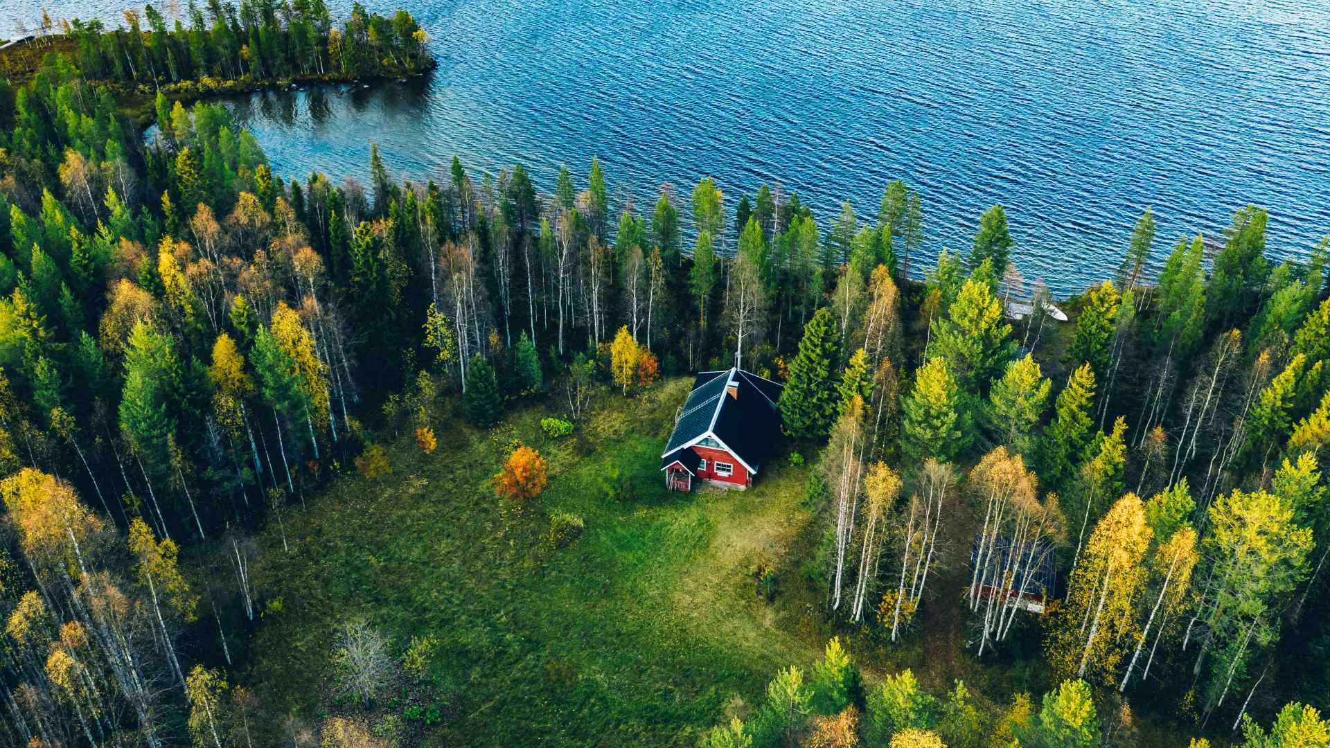 aerial view red cottage in forest finland
