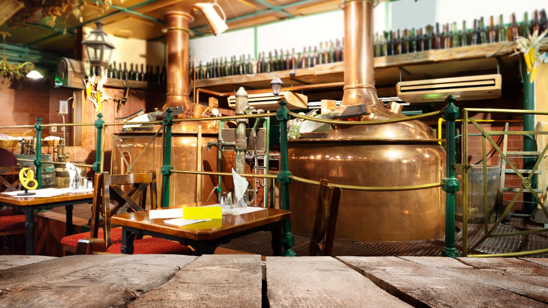 A glass tankard of beer on a wooden table in a Prague pub.