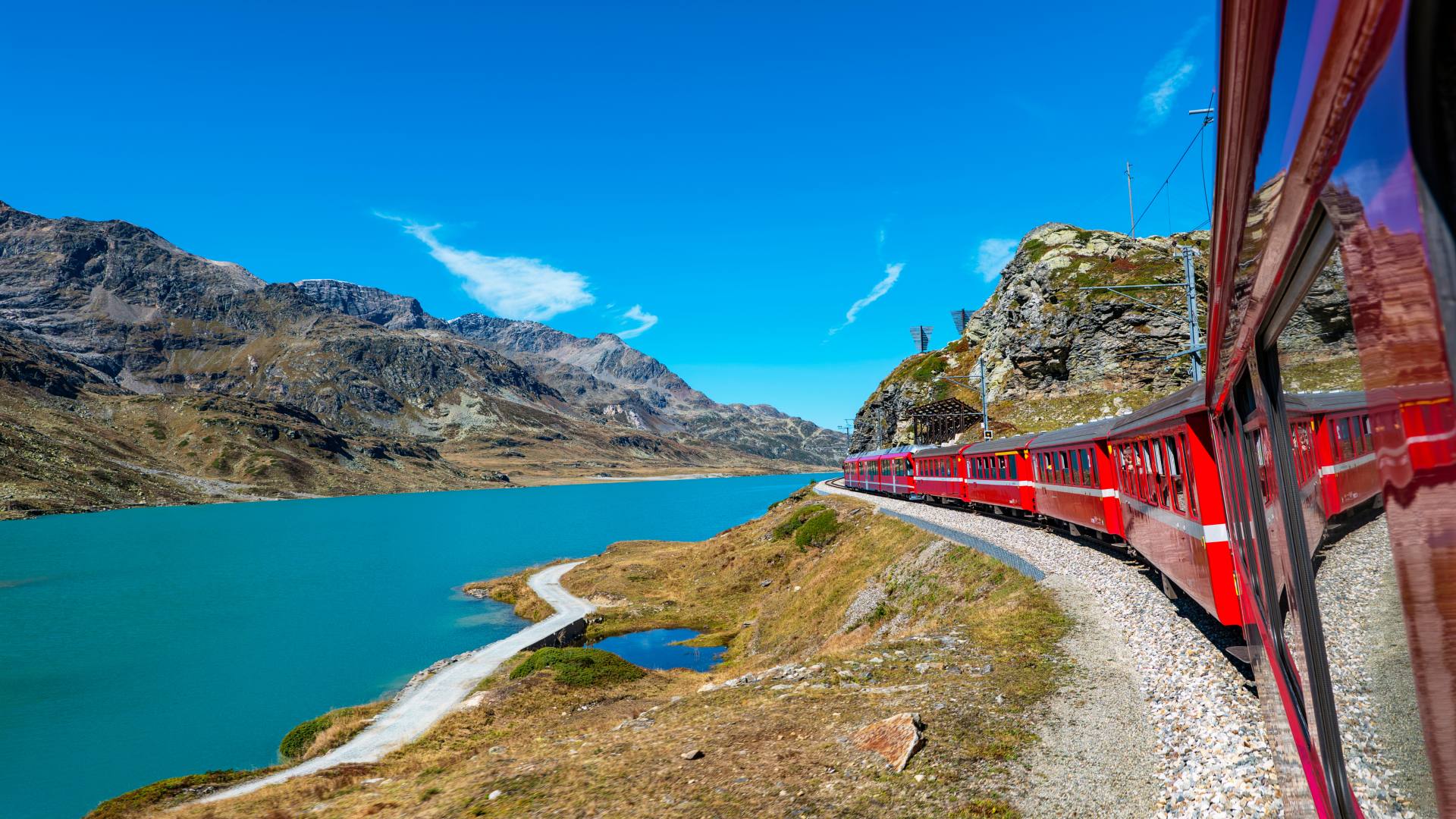 Red Bernina Express train crossing the Swiss Alps
