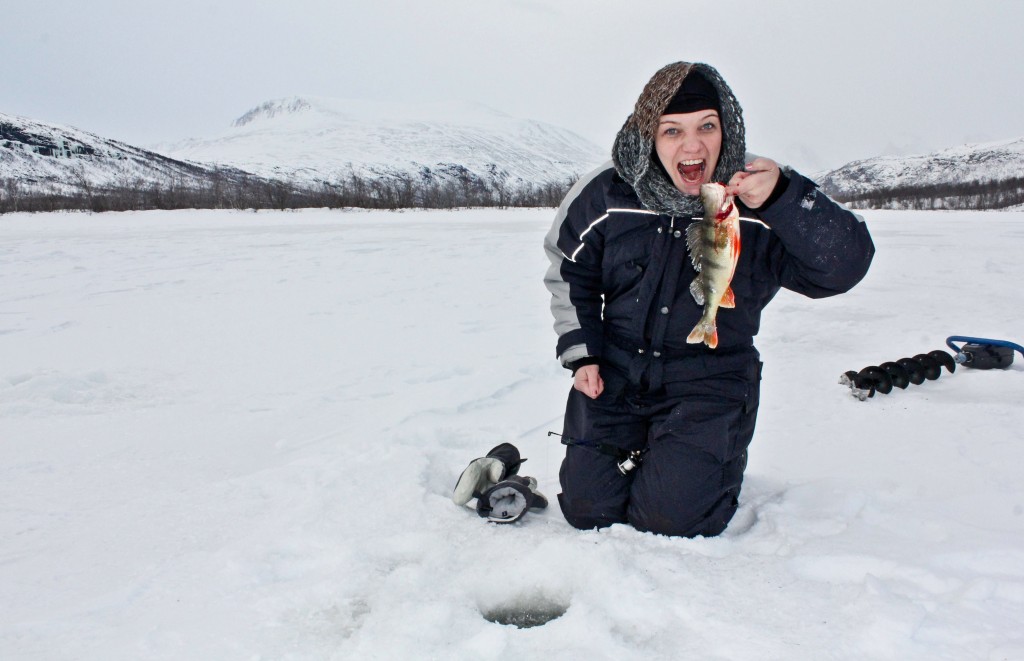 Arctic sushi? girl holding a freshly caught fish