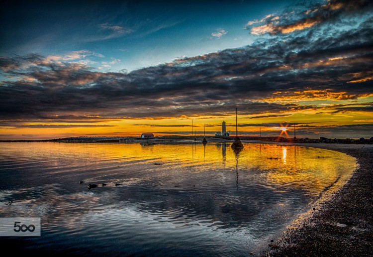 Grotta is a stunning spot to explore by day or night. Locals flock to this seaside vantage point to gawk at colourful sunsets and dazzling northern lights. (Photo by Dagur Jónsson)