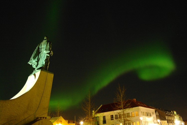 A emerald swirl of northern lights over central Reykjavík. Photo taken by Nordic Visitor employee Marco Fugallo.