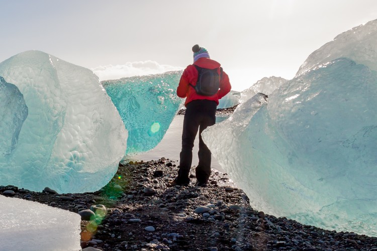 Andrea meanders between large icebergs from the Jökulsárlón glacier lagoon. (Photo by Michael Howe)
