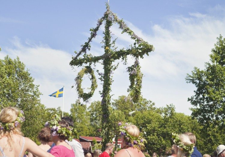 Swedes dance around the maypole to mark midsummer (photo credit).