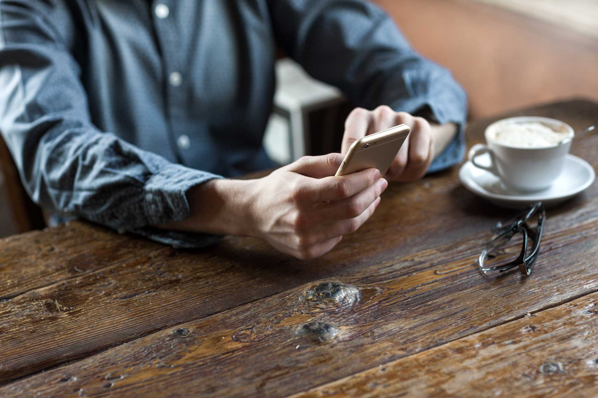 Man with phone using internet at cafe in Scandinavia