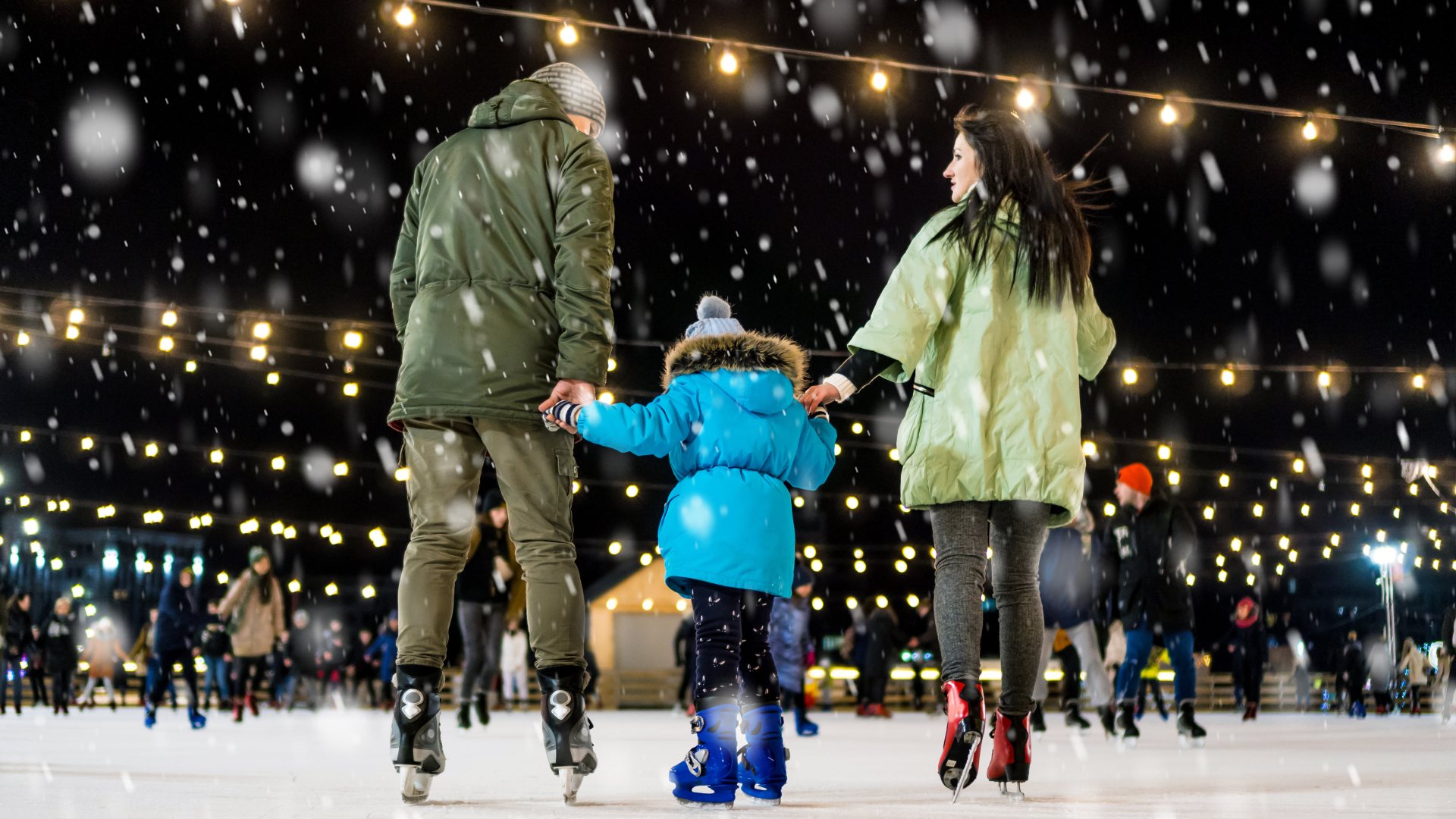 A family ice skating on an outdoor rink in Prague