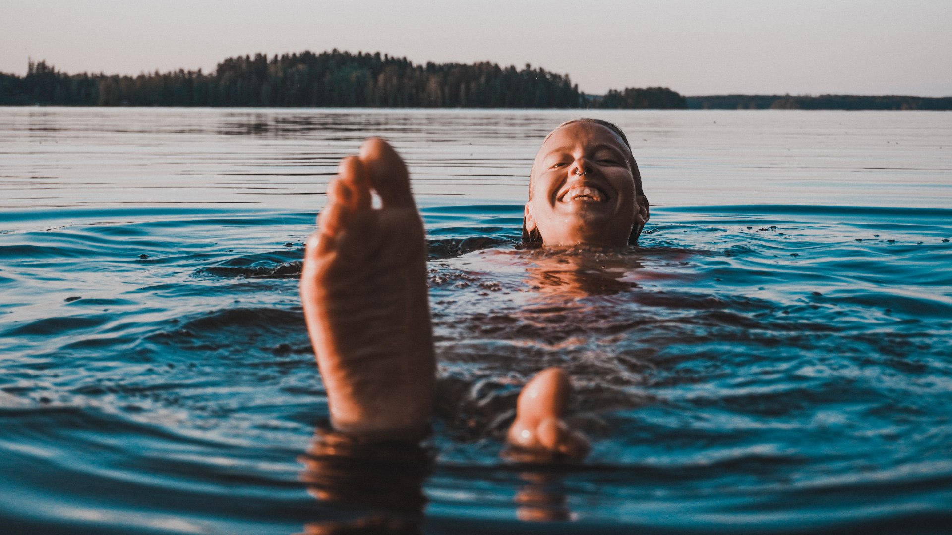 Girl swimming in a Finnish lake