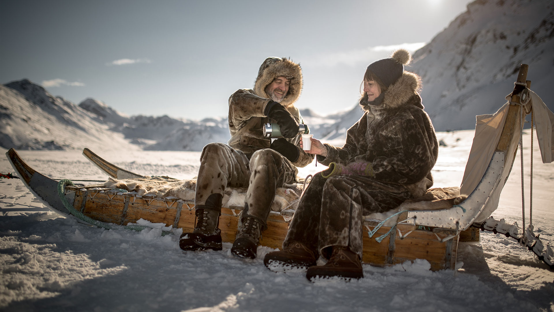 People enjoying coffee on a traditional Inuit sled © Mads Pihl