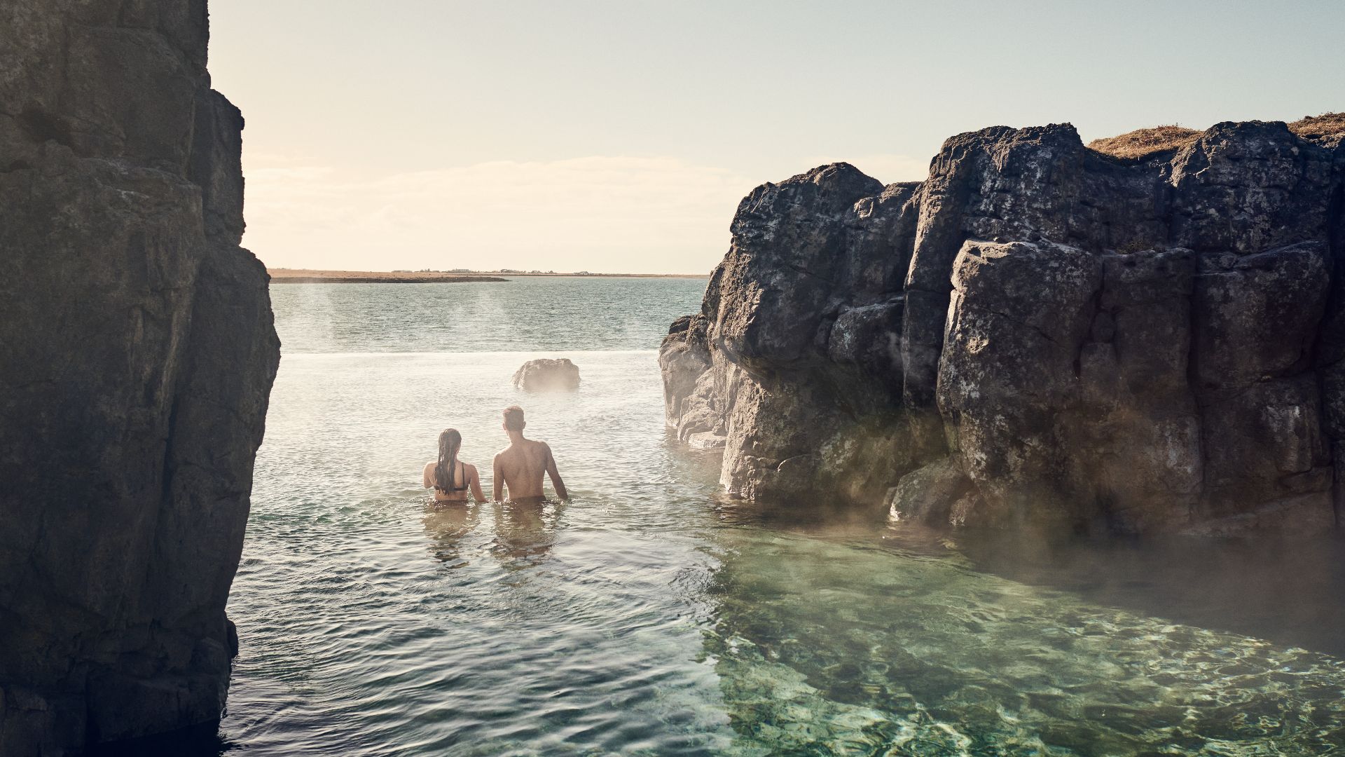 Couple relaxing in the Sky Lagoon geothermal pool, Iceland