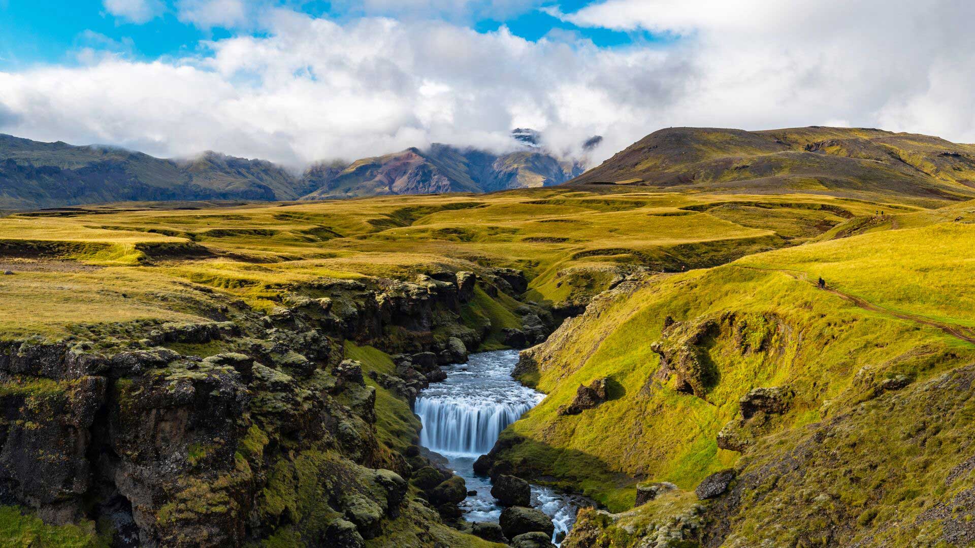 Waterfall and rolling green landscape in Fimmvorduhals, Iceland