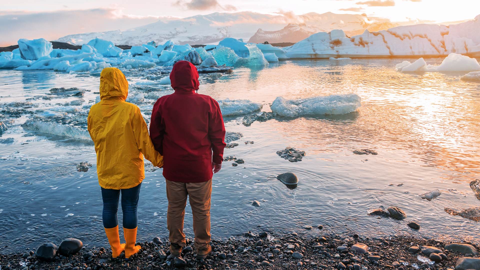 Couple at Jökulsárlón glacier lagoon at sunset