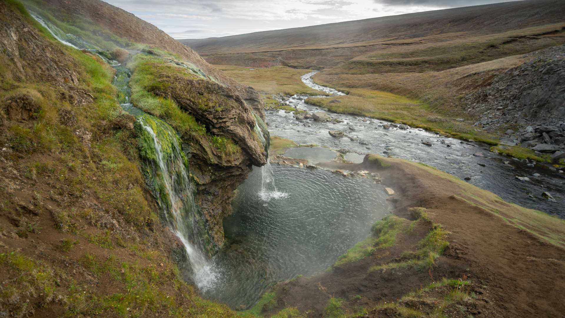 Laugavallalaug Hot Pot with small waterfall in Iceland