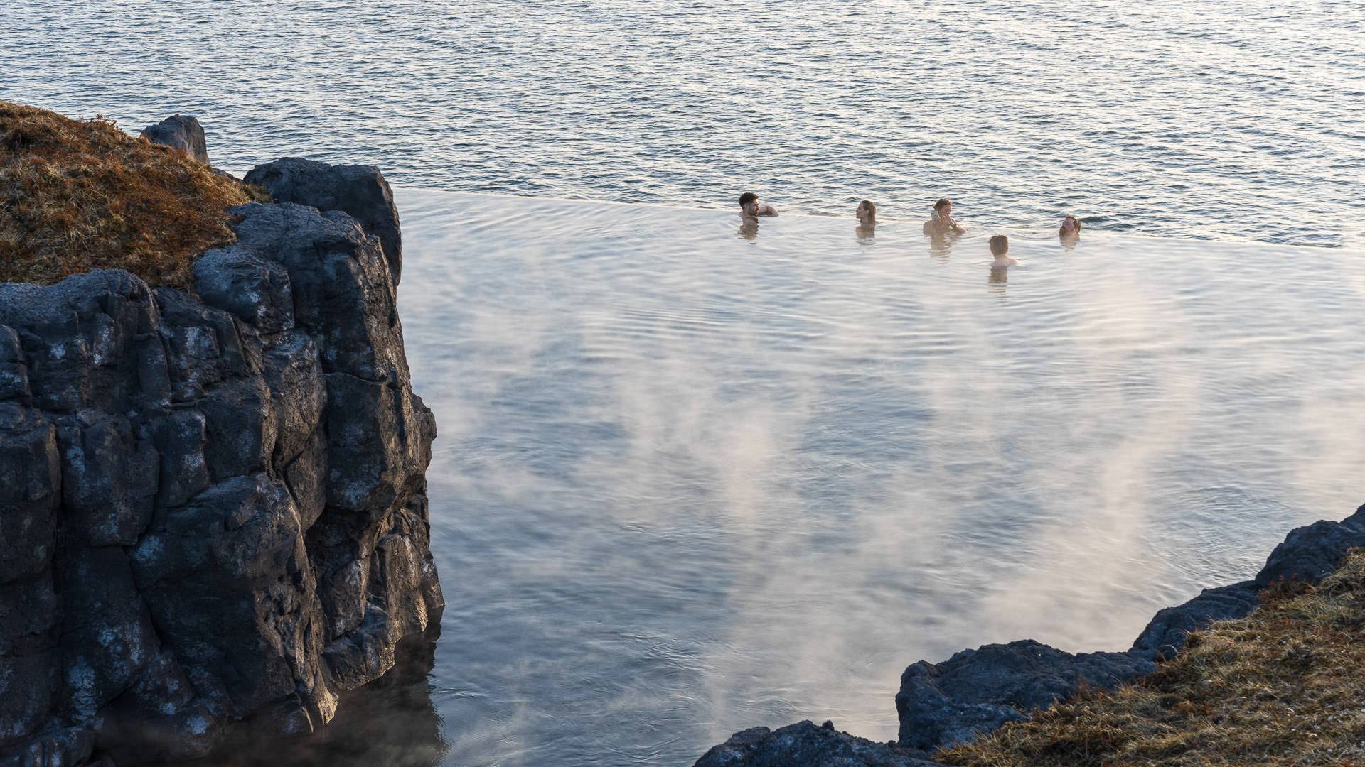 people swimming in the sky lagoon