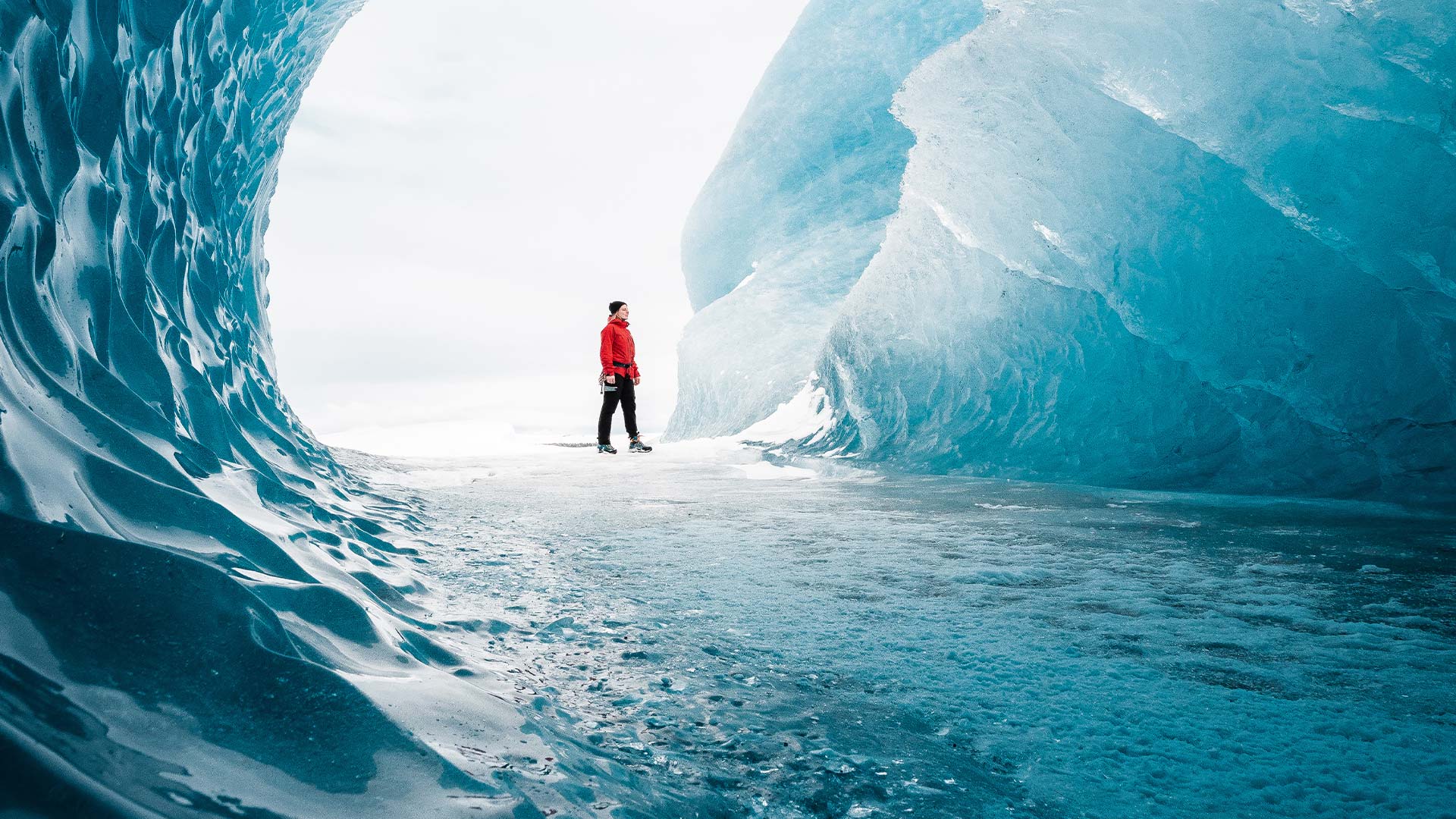 Human scale inside frozen ice cave Vatnajökull Glacier
