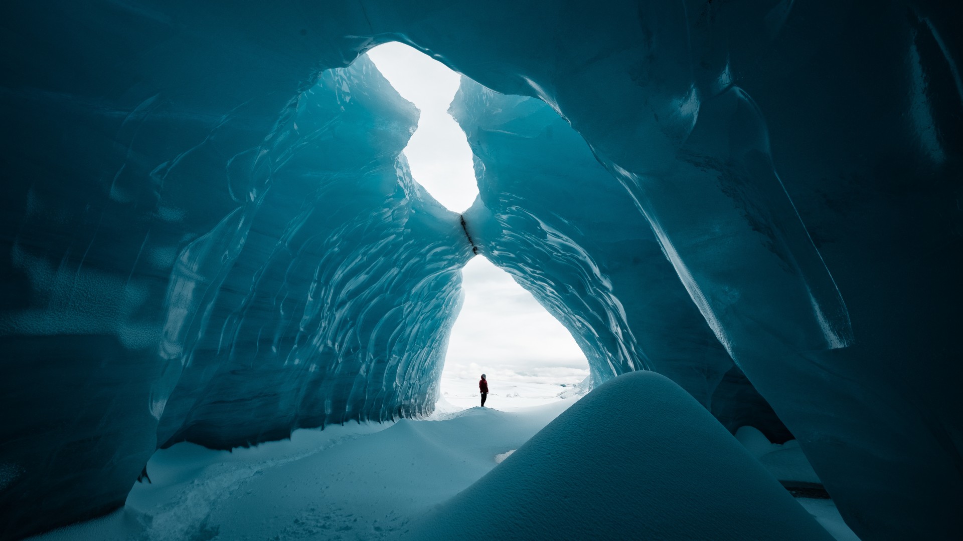 Person is standing an ice cave in Vatnajökull glacier