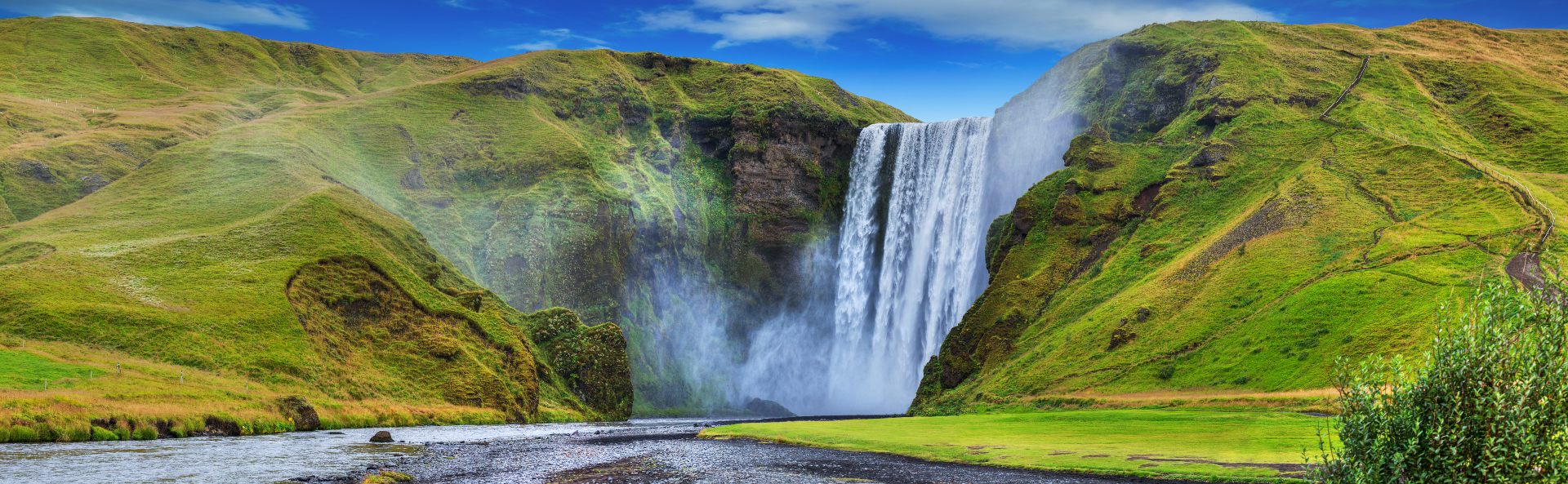 Thundering waterfall surrounded by tranquil greenery.