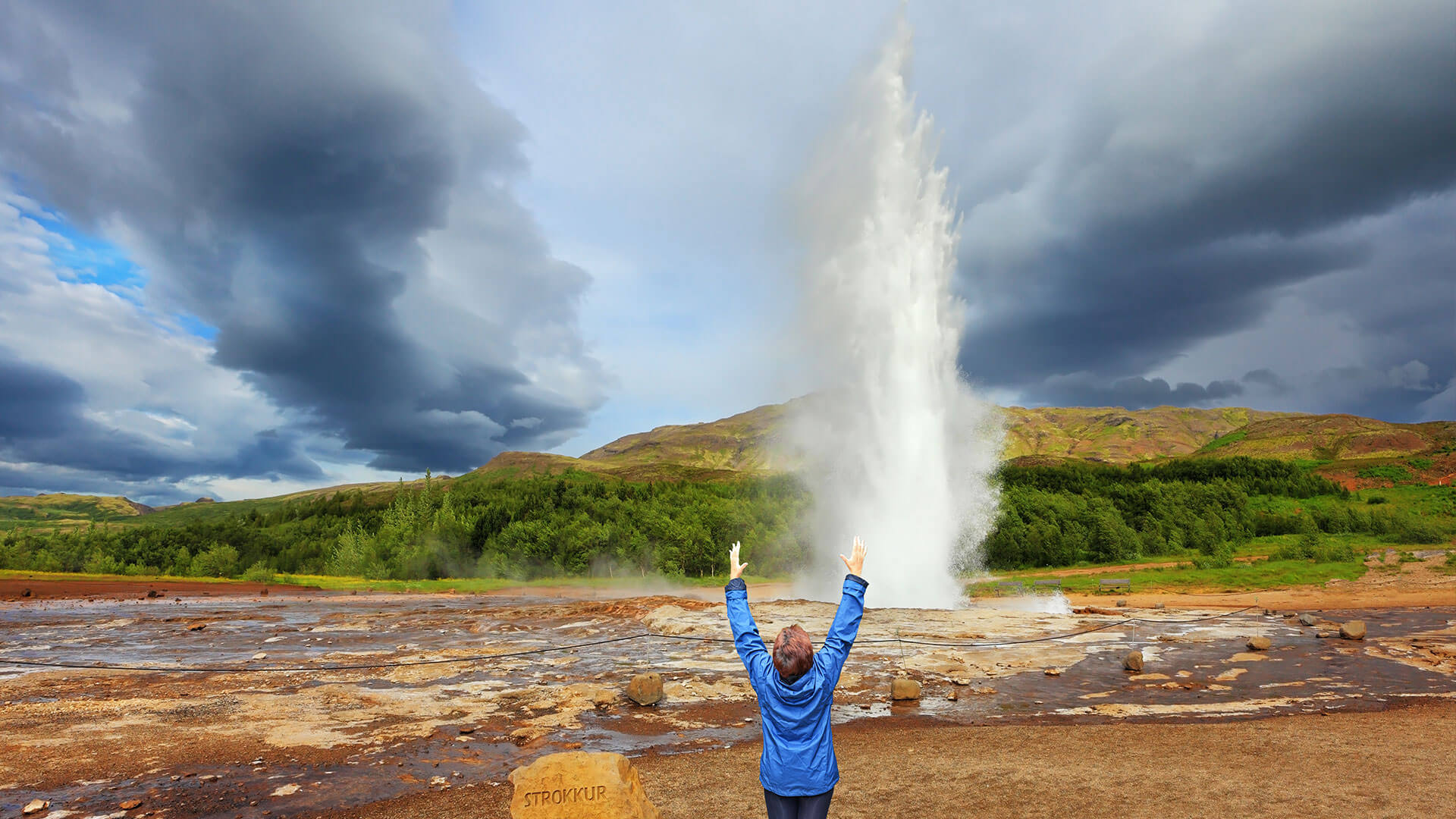 person standing at Strokkur geysir