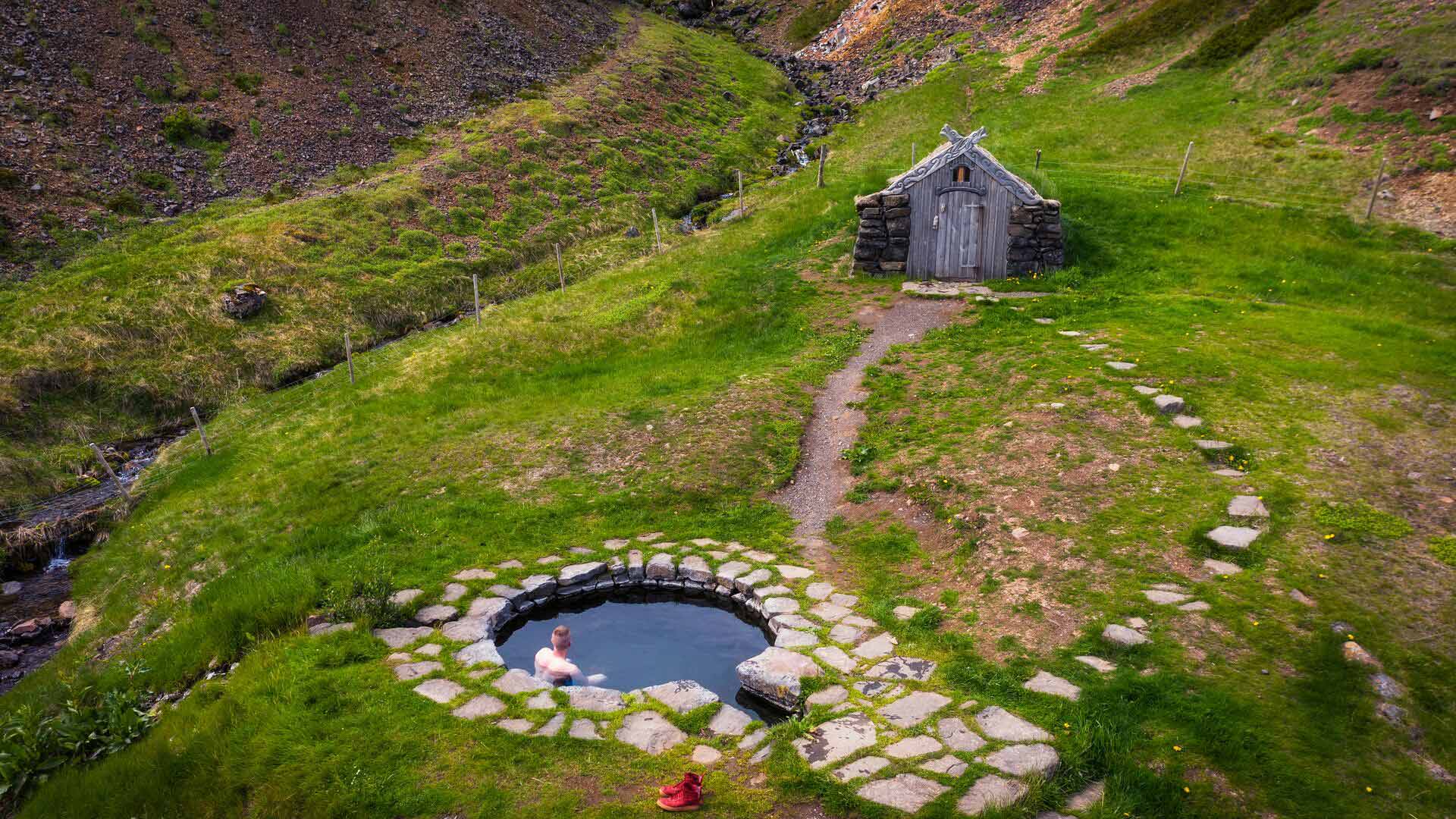 Gudrunarlaug hot spring by the river