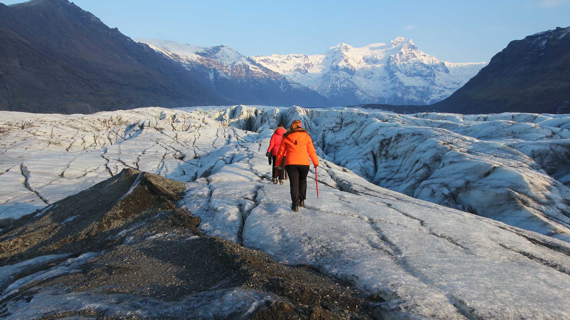 people hiking on glacier