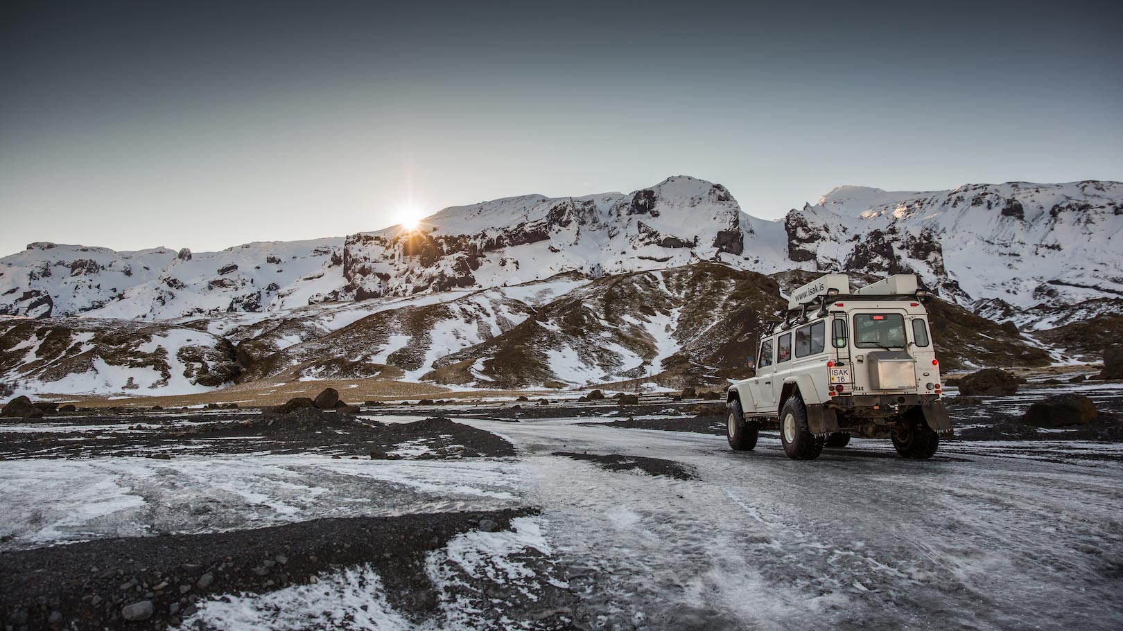 A 4x4 superjeep driving through snow-dusted Þórsmörk valley