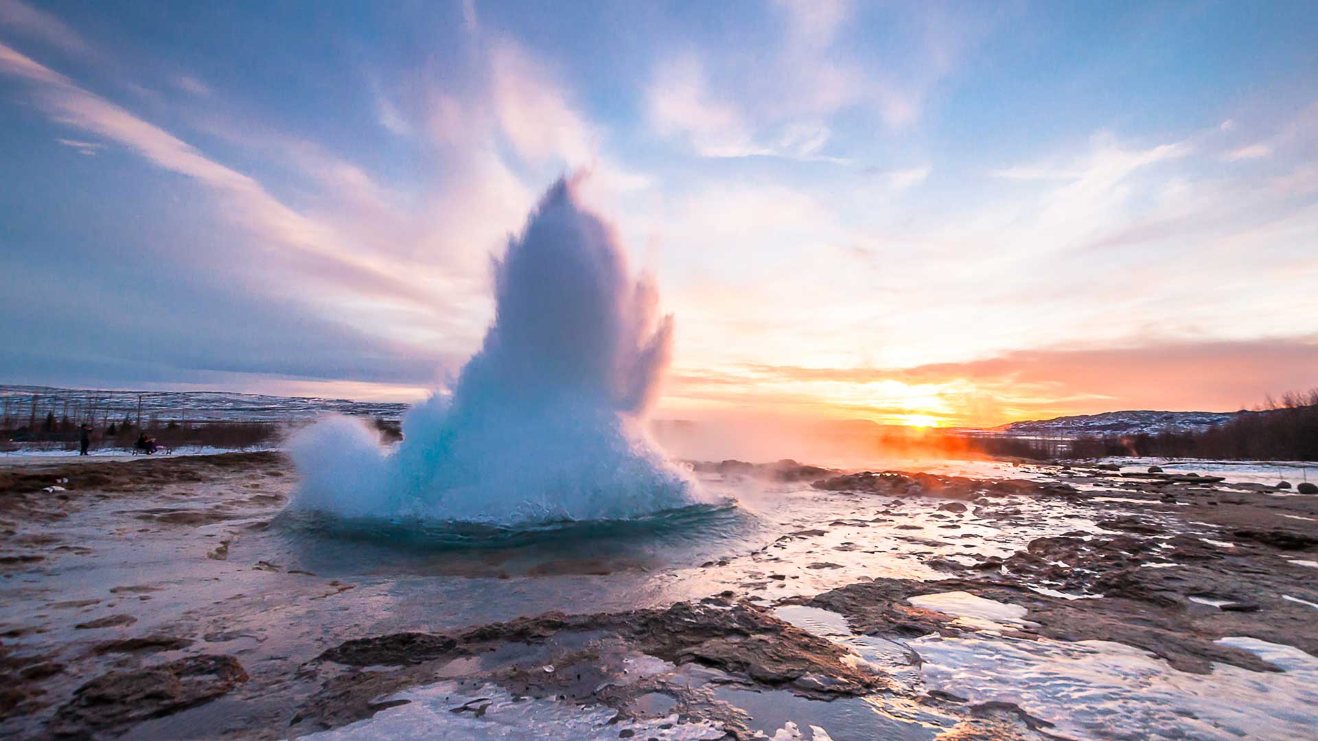 Geysir erupting at sunset