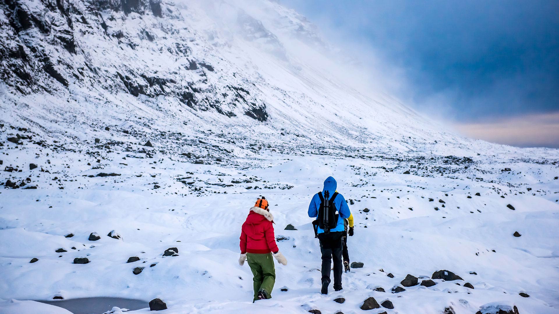 couple hiking in snow in winter