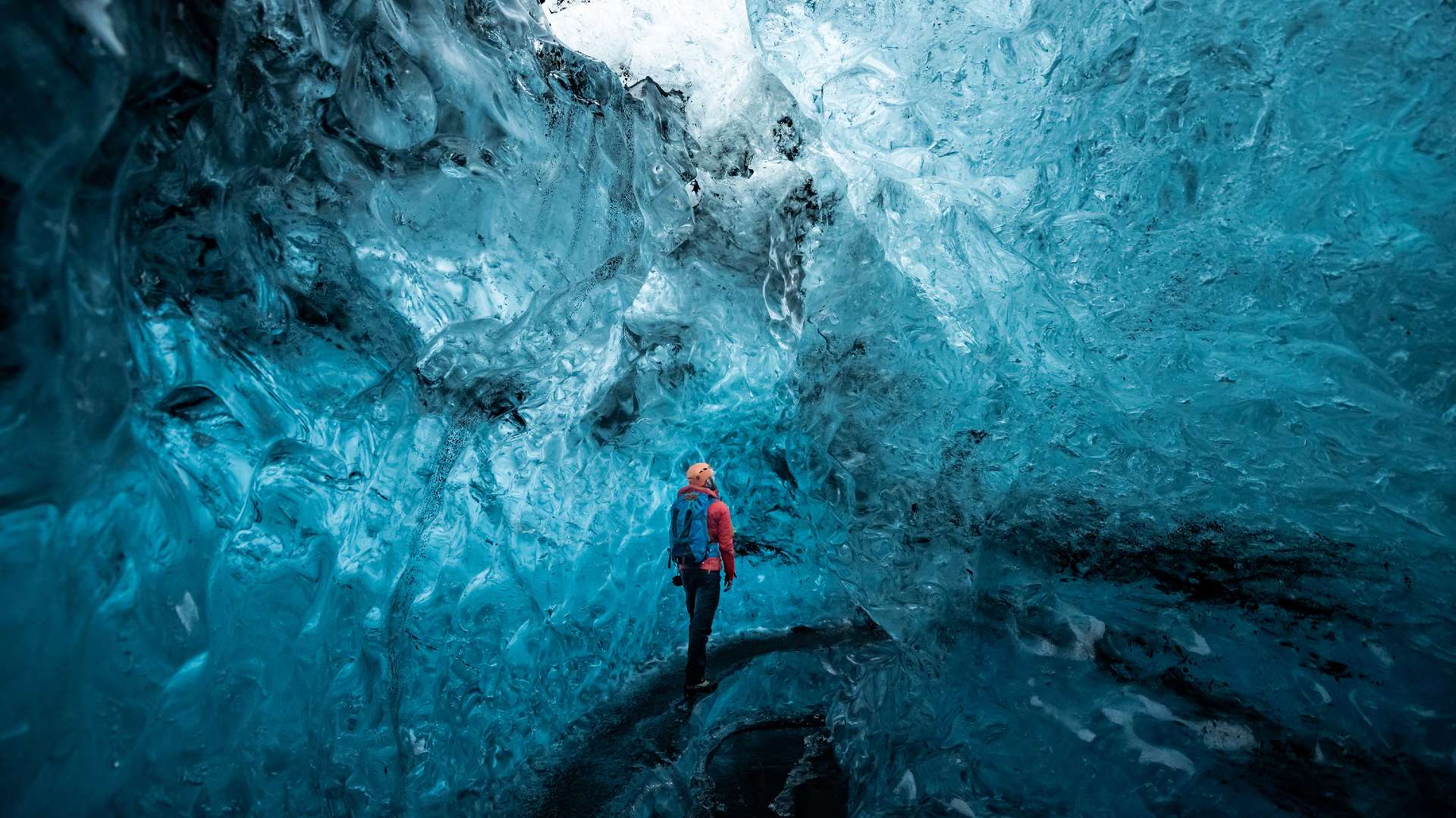 The tall blue walls of a glassy ice cave.