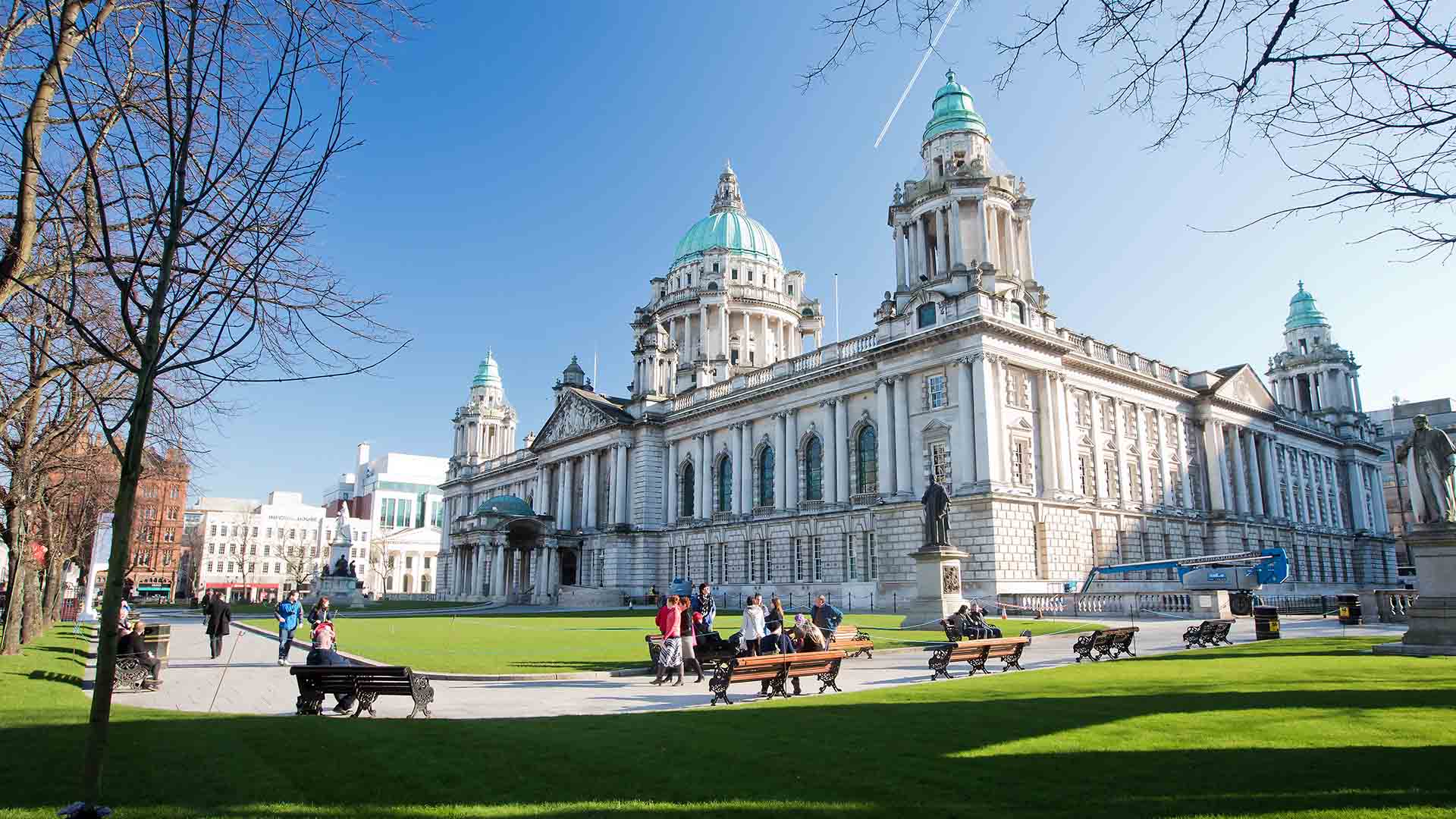 People enjoying the warm weather outside of the grand Belfast City Hall