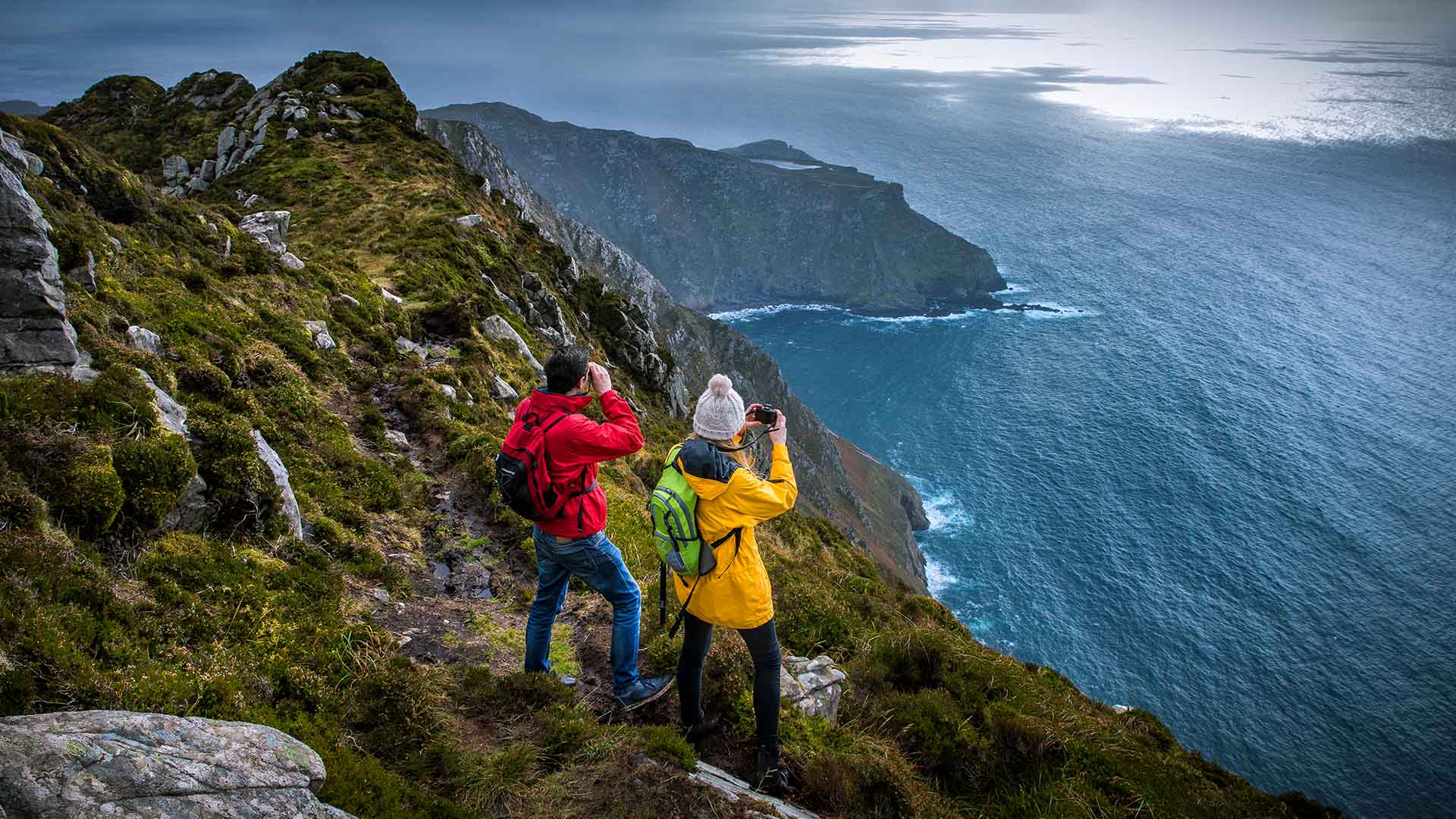 couple standing by slieve league cliffs