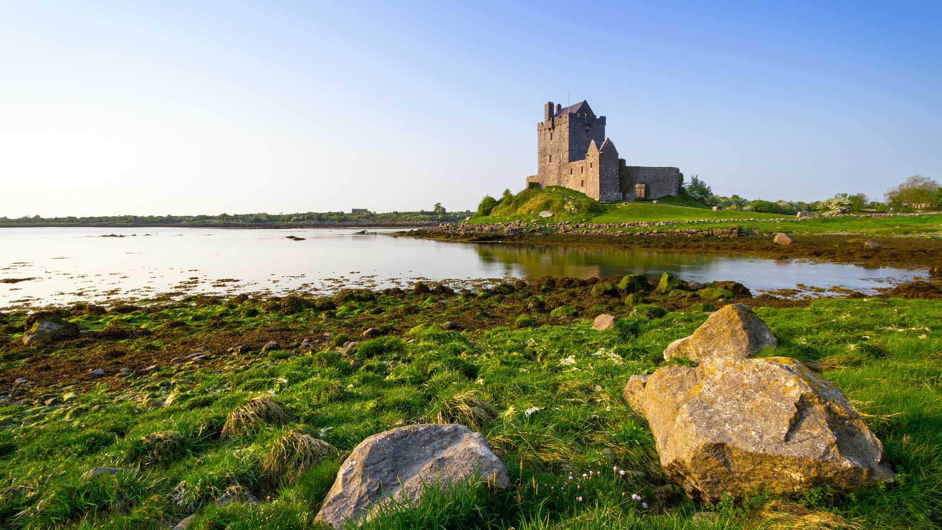 view of dunguaire castle by the water