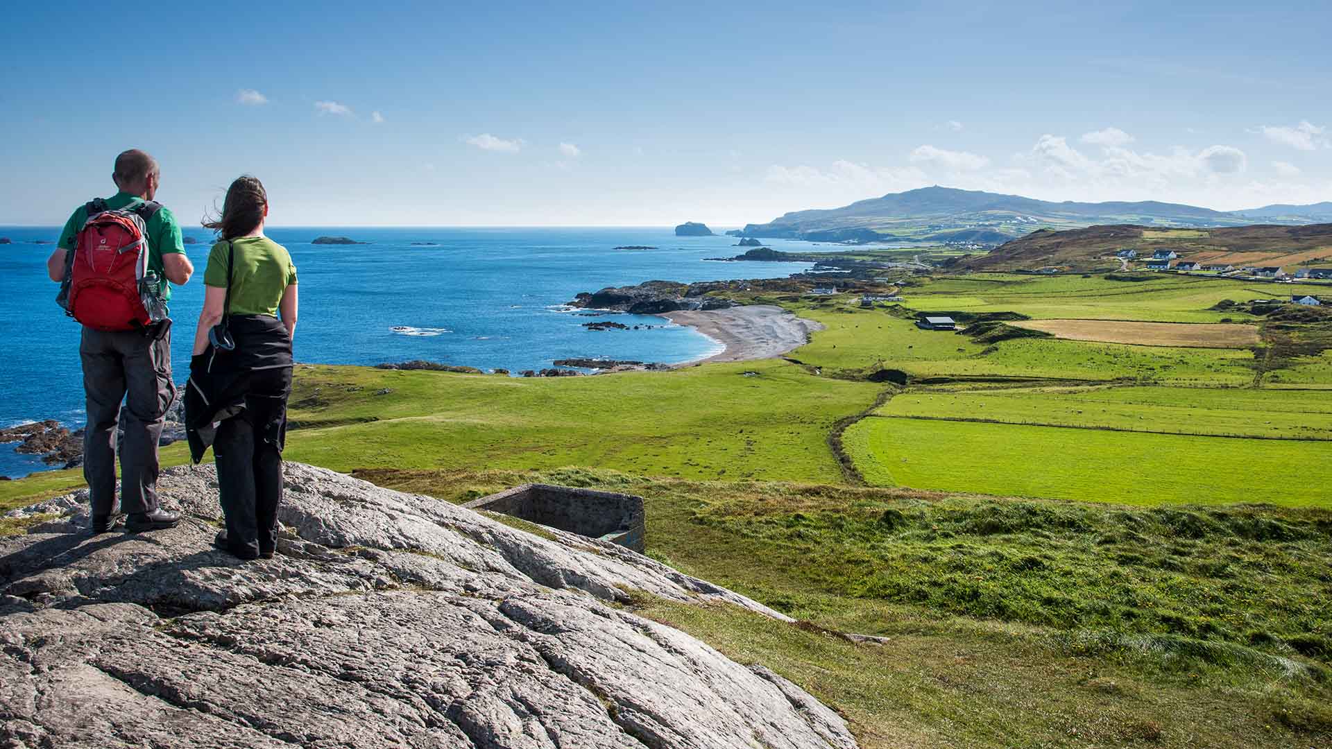 couple standing atop malin head