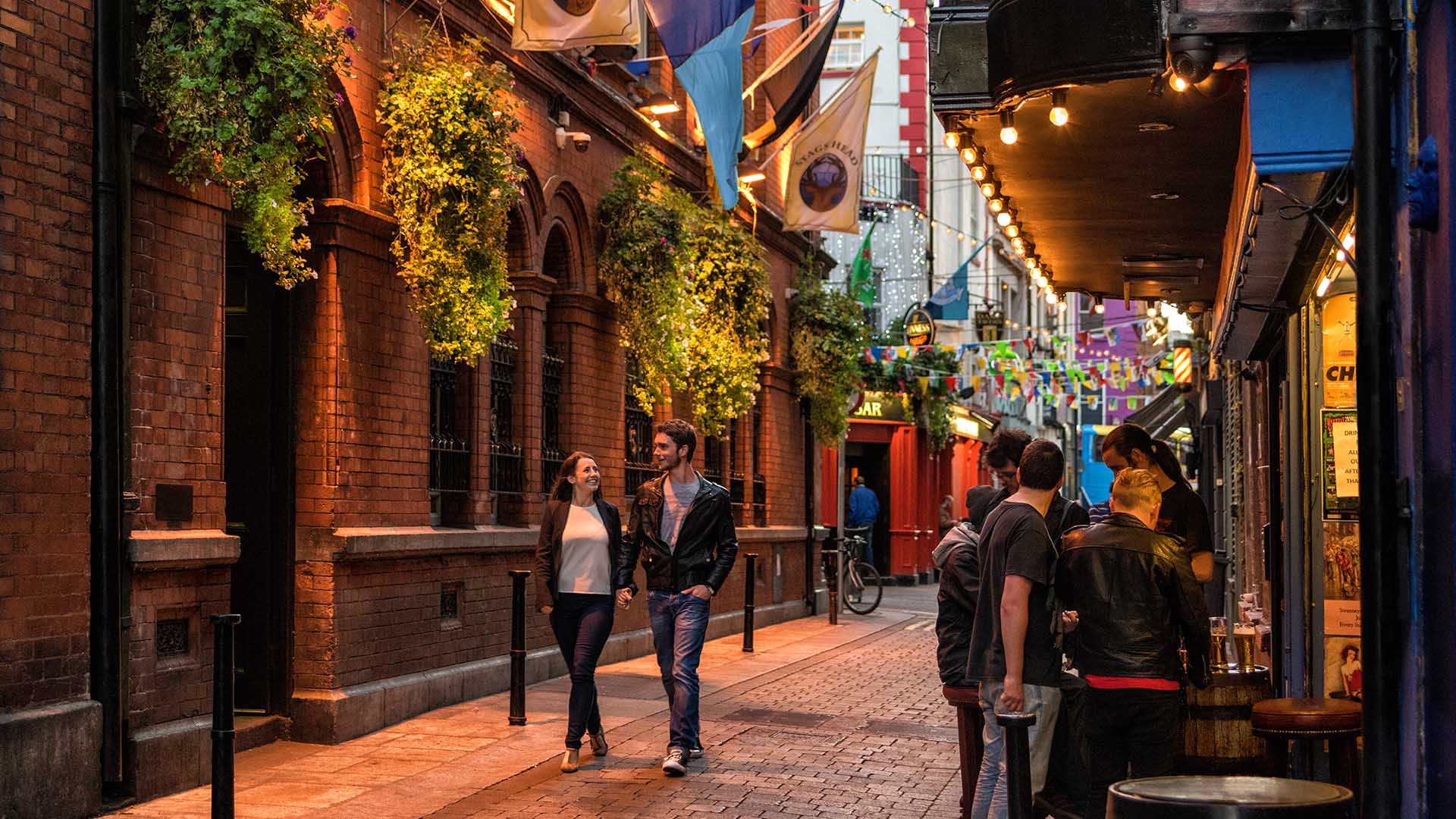 people walking by pubs in dublin