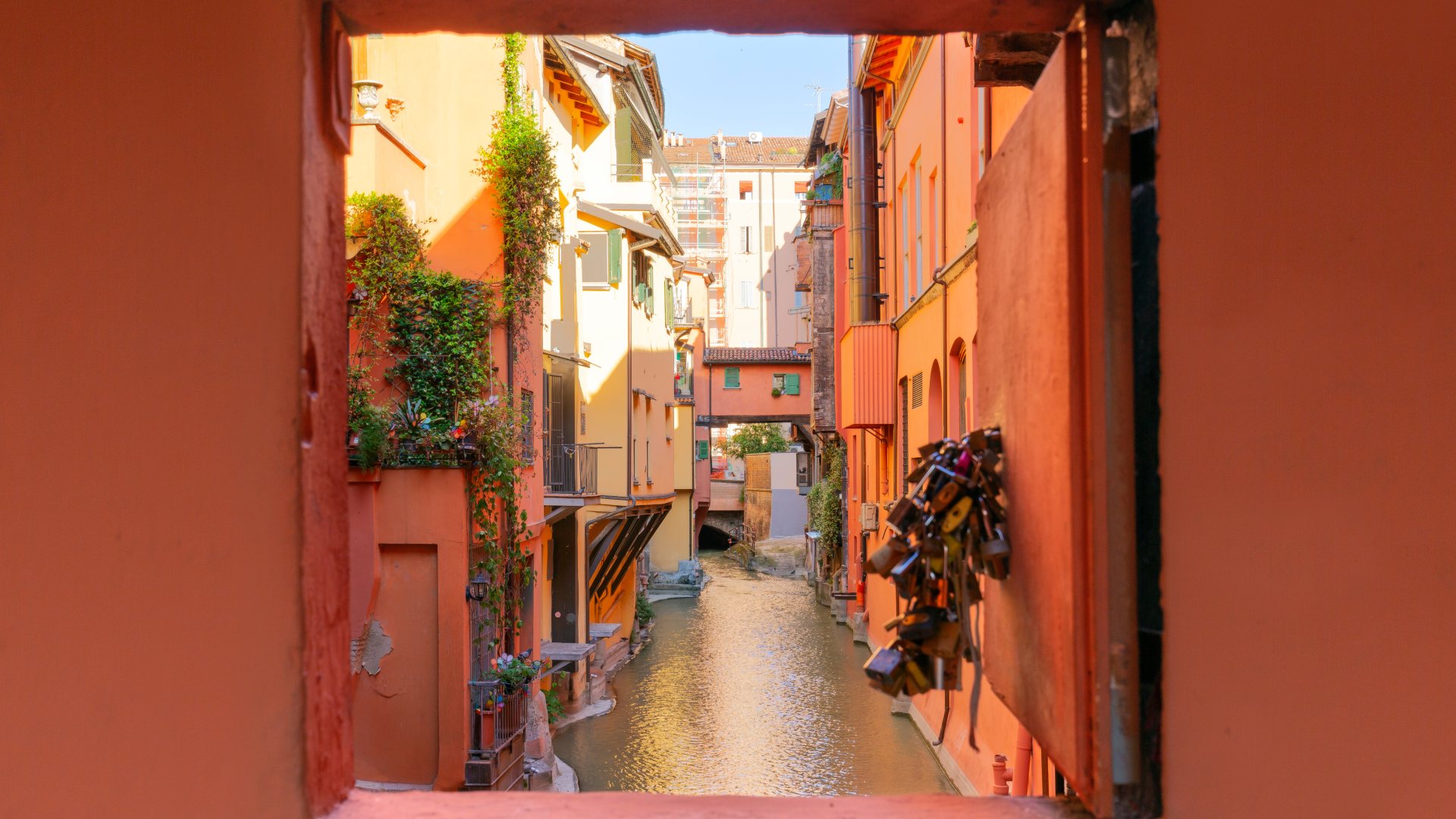 Secret window in the wall overlooking the canal in the city of Bologna, Italy.