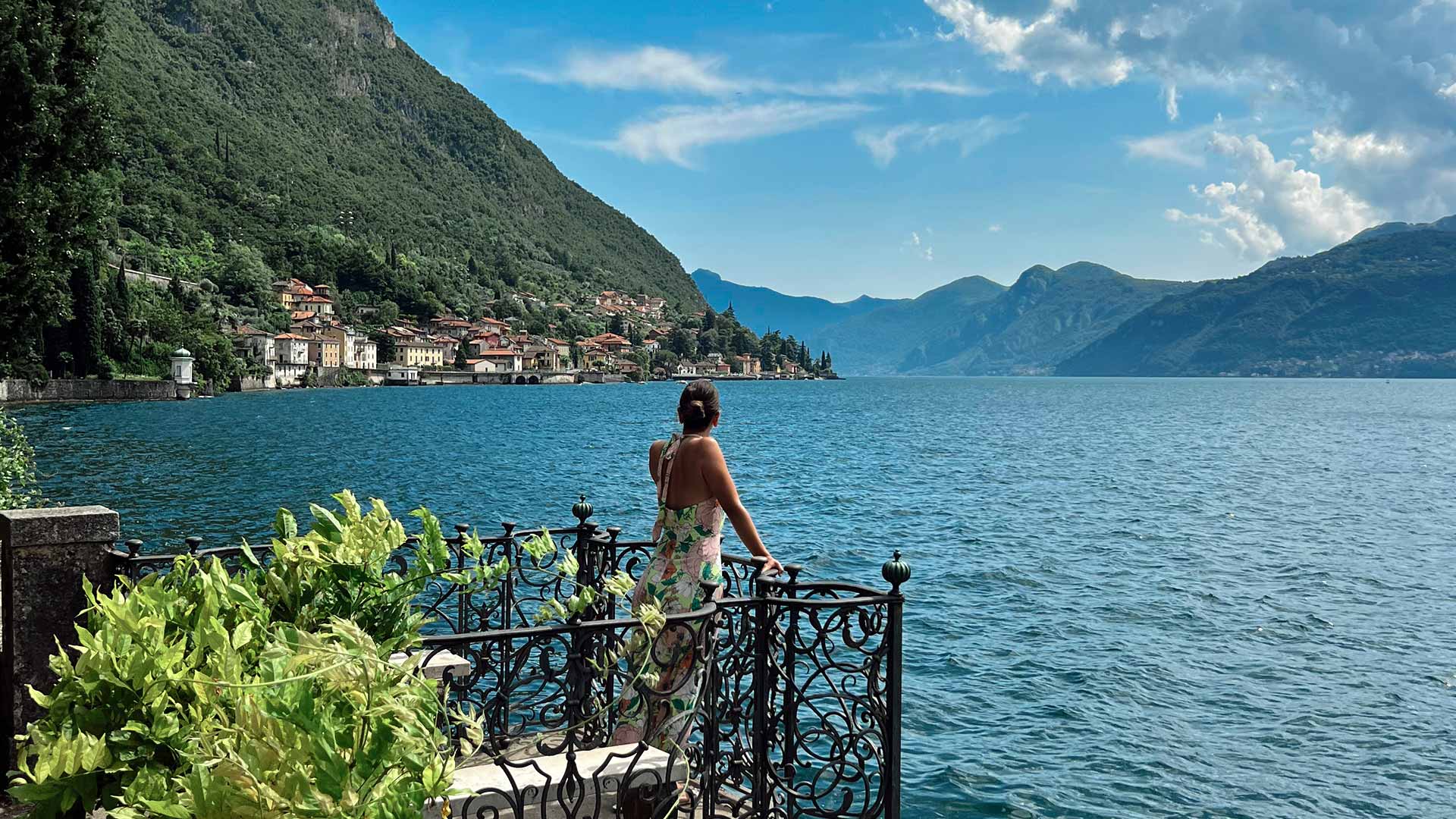 Woman on balcony gazing at Lake Como