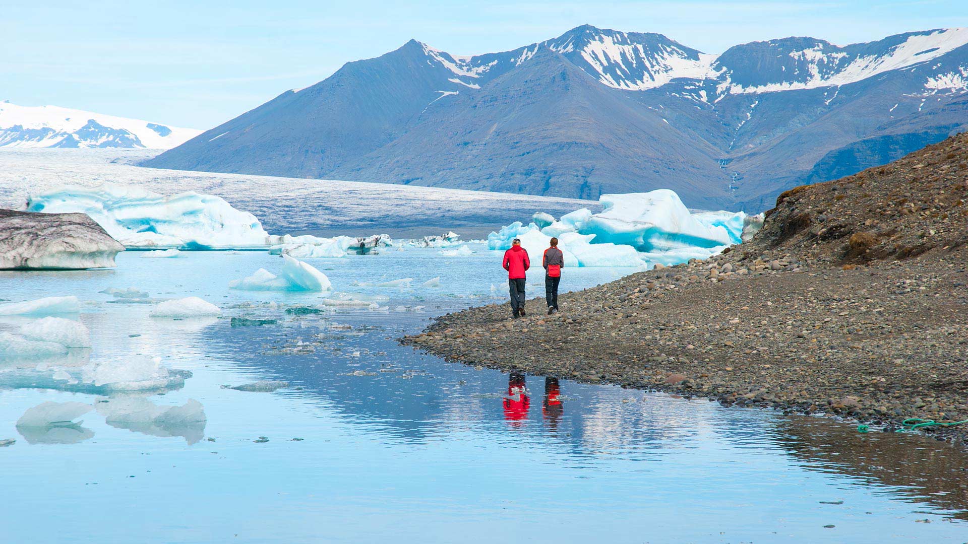 A couple taking in the icy sights at Jökulsárlón Glacier Lagoon in South Iceland