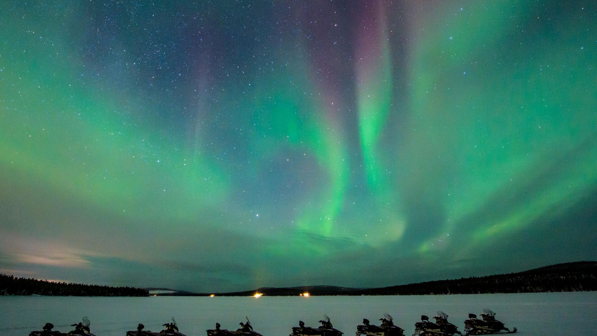 northern lights during snowmobile excursion