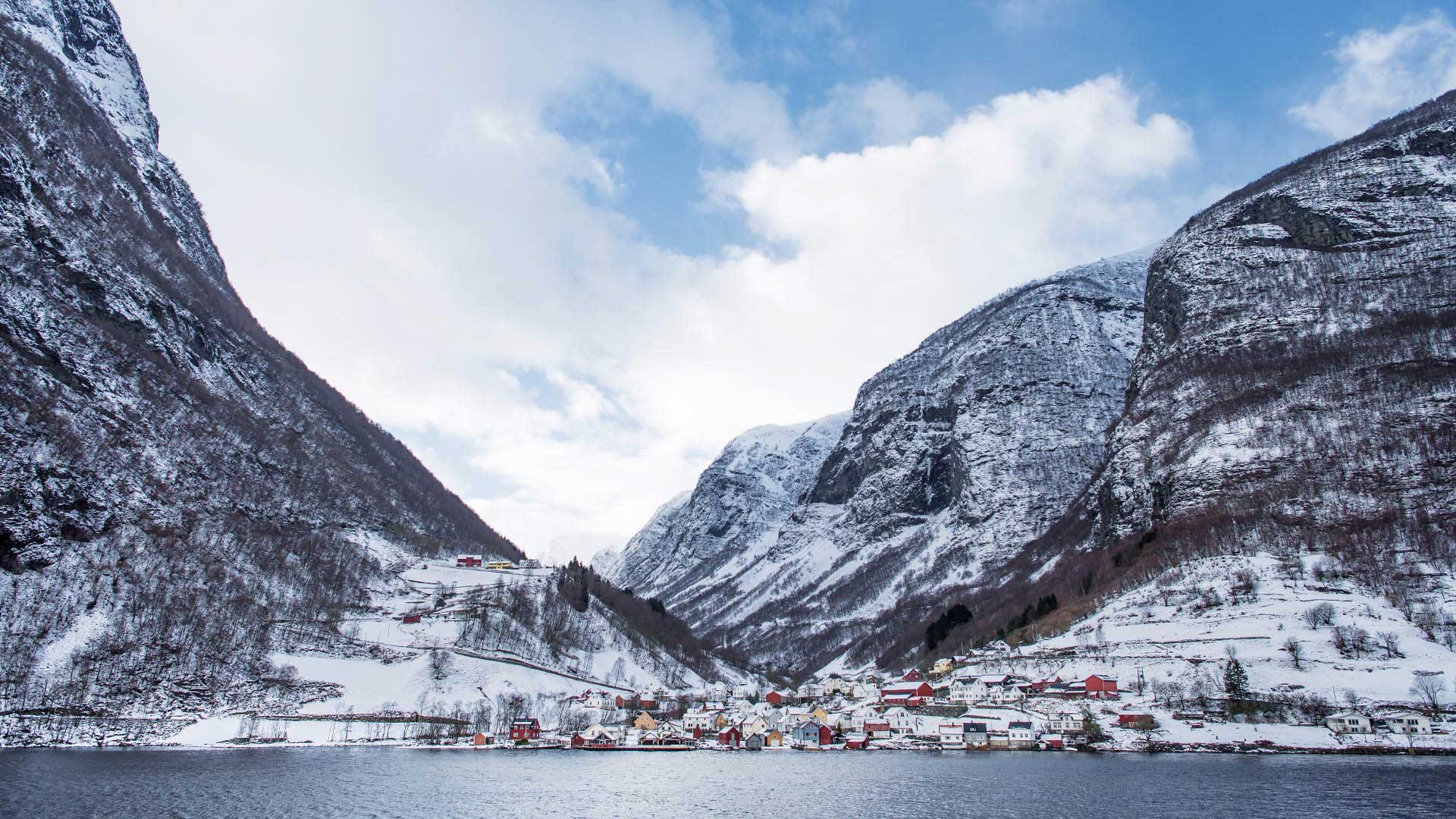village of Flam and snowy mountains