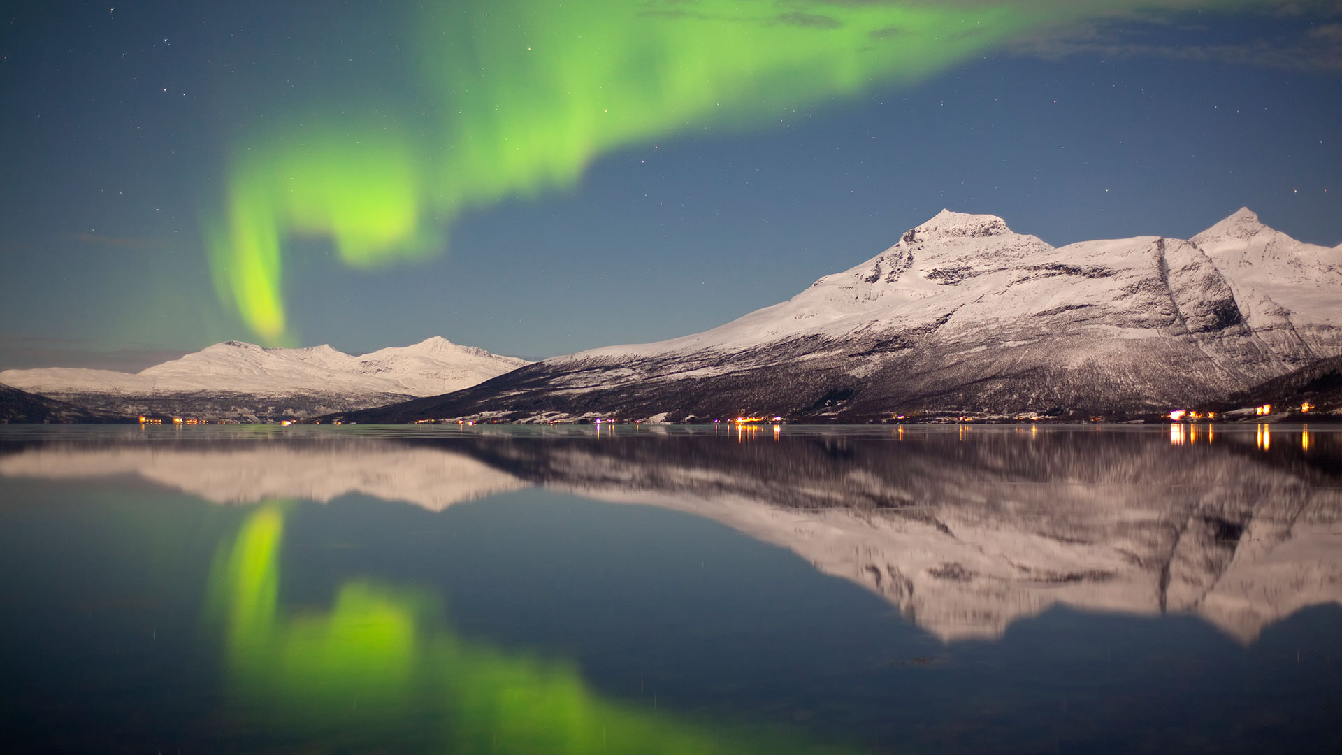 Northern Lights over tromso and snowy mountains