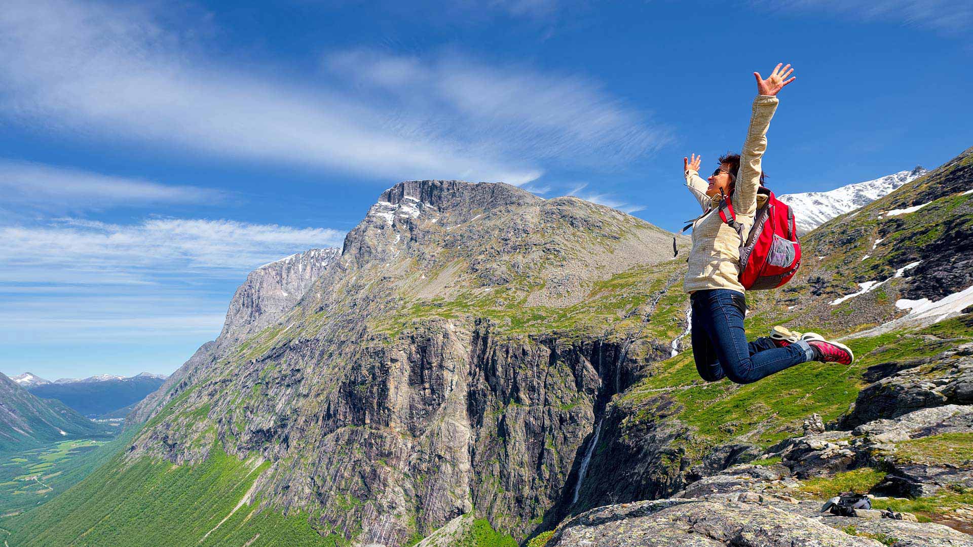 person jumping in front of Trollstigen, Norway