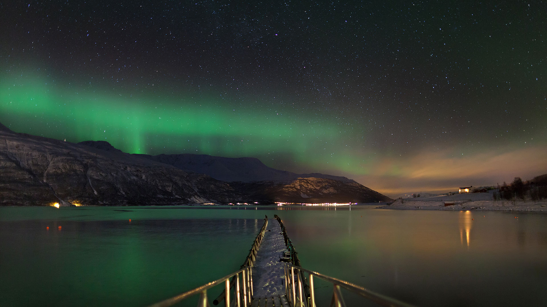 northern lights above mountains and sea