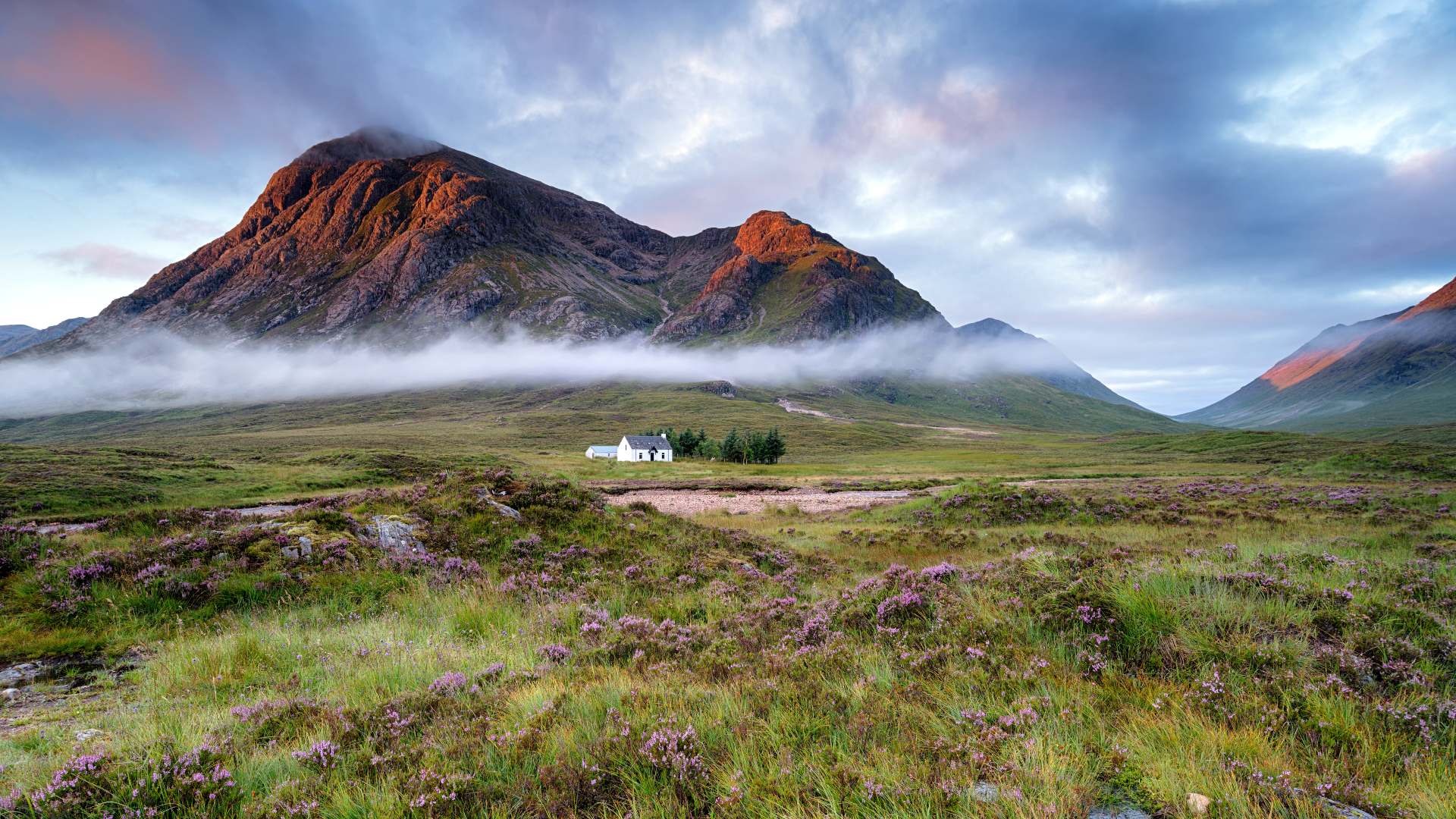 Sunrise at Glen Coe with a charming white cottage 